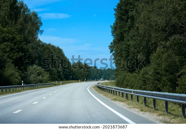 Beautiful road\
in the beautiful trees. A country road in the summer. Empty race\
track. highway . High quality\
photo