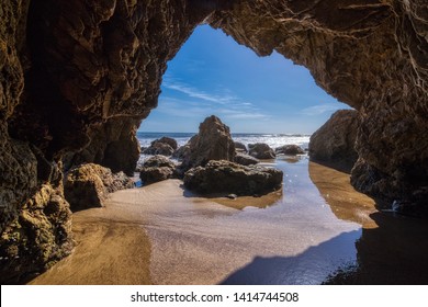 Beautiful rock arch with a view of the ocean at the popular El Matador Beach along the Southern California coast, Malibu, California