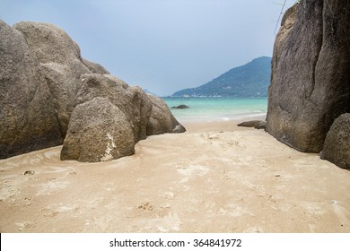 Beautiful rock beach with sea ocean and mountain blue sky landscape background