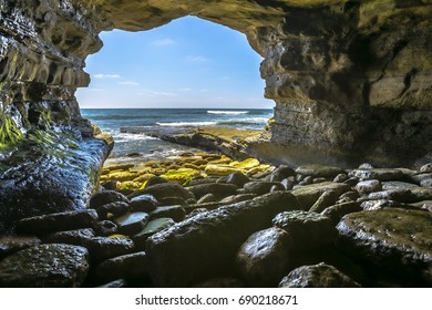 The beautiful rock cave at the sea in La Jolla California at an angle. The beautiful rock cave at the sea from the inside of the cave at mid day.