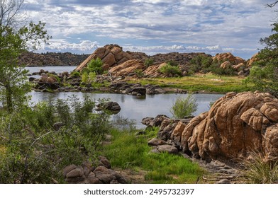 Beautiful rocky landscape at Watson Lake in Prescott, Arizona with calm water, lush greenery, and a clear sky on a tranquil day. Perfect for nature and outdoor enthusiasts. - Powered by Shutterstock