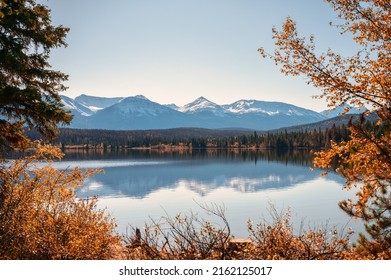 Beautiful rocky mountains with autumn leaves reflection in Pyramid lake at Jasper national park, AB, Canada
