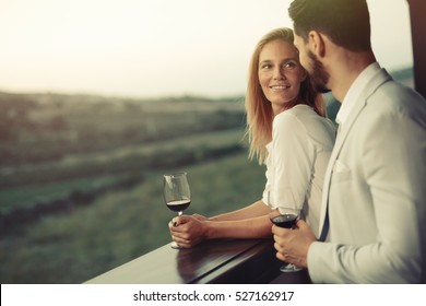 Beautiful romantic couple drinking wine - Powered by Shutterstock