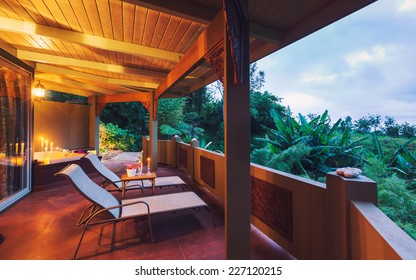 Beautiful Romantic Deck On Tropical Home At Sunset With Candles