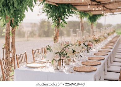 Beautiful romantic elegant wedding decor for a luxury dinner in Italy, Tuscany. Modern floral design for outdoor wedding 