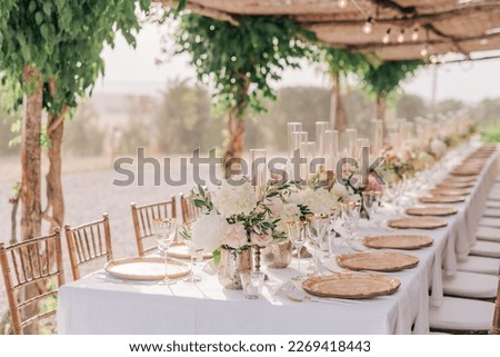 Beautiful romantic elegant wedding decor for a luxury dinner in Italy, Tuscany. Modern floral design for outdoor wedding 