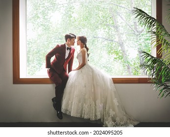 A beautiful, romantic and happy couple on their wedding day. Korean Asian male and female models. A bride in a gorgeous and beautiful wedding dress. Asian couple.  - Shutterstock ID 2024095205