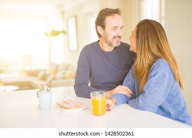 Beautiful romantic middle age couple having healthy breaskfast in the morning at home - Shutterstock ID 1428502361
