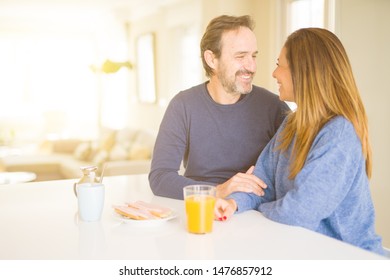 Beautiful romantic middle age couple having healthy breaskfast in the morning at home - Shutterstock ID 1476857912