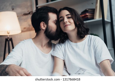 beautiful romantic young couple in pajamas at home in bed - Shutterstock ID 1317868418