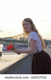 Beautiful Romantic Young Woman Posing On A City Background With Roses. Inspiration Of Spring And Summer. Girl On A Date. No People Around, Female Portrait. 