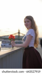 Beautiful Romantic Young Woman Posing On A City Background With Roses. Inspiration Of Spring And Summer. Girl On A Date. No People Around, Female Portrait. 