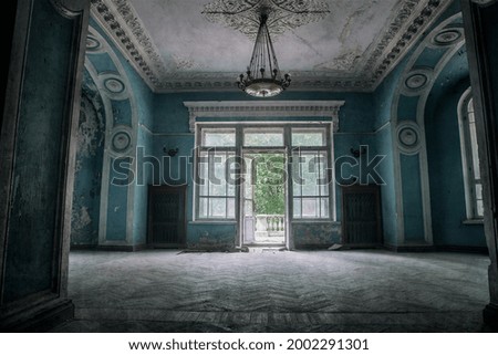 A beautiful room with shabby walls in an old abandoned house. Abandoned haunted manor. Ancient architecture and interiors.