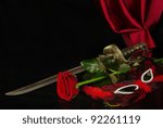 Beautiful  rose, mask and sword. Black background