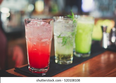 Beautiful row line of different colored alcohol cocktails on a party, martini, vodka,and others on decorated catering bouquet table on open air event, picture with beautiful bokeh
 - Powered by Shutterstock