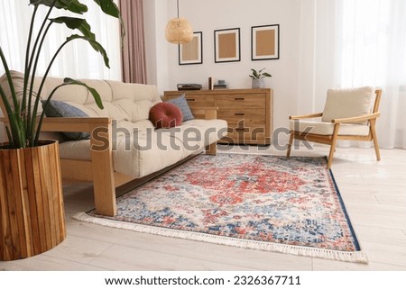 Beautiful rug, sofa, armchair and chest of drawers indoors