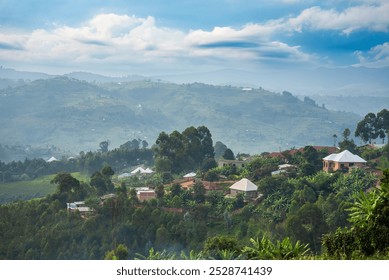 A beautiful rural landscape in Burundi, featuring traditional homes nestled among rolling green hills, dense vegetation, and a cloudy sky. The mountainous backdrop adds depth to the scenic view. - Powered by Shutterstock