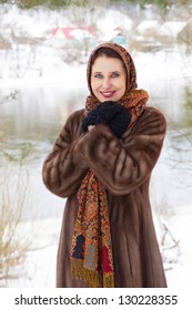 Beautiful Russian Woman In Fur Coat And Shawl Standing On Coast