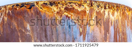 Beautiful rust pattern on the side of a metal storage tank. Corrosion caused by acidic water from Bjarnarflag Geothermal Power Station, near Krafla volcano, Iceland.