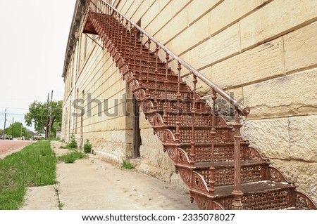A beautiful, rusted staircase for the fire escape of a historic building in rural Texas
