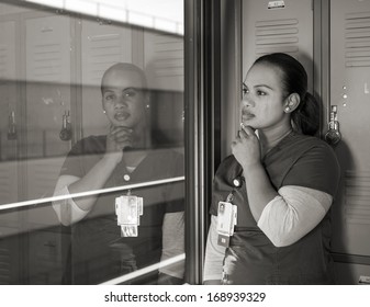 Beautiful Sad African American Nurse Crying In A Locker Room In Monochrome