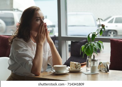 Beautiful Sad Female Sitting Alone At The Cafe. Sad Young Woman Deep In Cafe. She Is Sad.