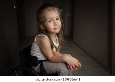 Beautiful Sad Girl Child Disabled Child Sitting In A Wheelchair. Victims Of A Car Accident. Disabled Children Concept