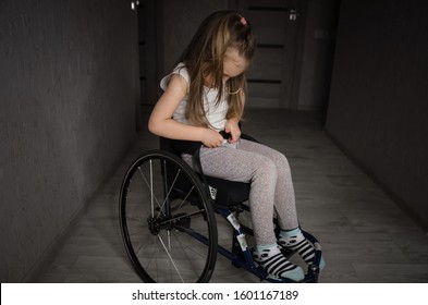 Beautiful Sad Girl Child Disabled Child Sitting In A Wheelchair. Victims Of A Car Accident. Disabled Children Concept	
