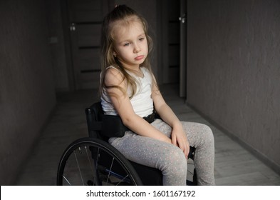 Beautiful Sad Girl Child Disabled Child Sitting In A Wheelchair. Victims Of A Car Accident. Disabled Children Concept	
