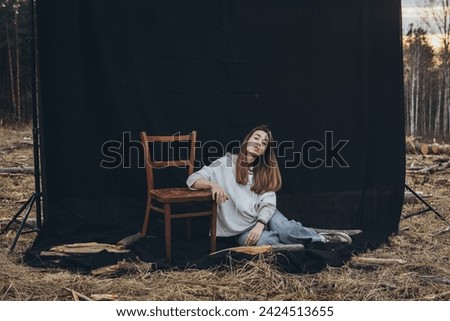 Similar – ein Mädchen mit langen Haaren und blauen Augen in den Bergen, das mit einer Kapuze lächelt