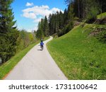 Beautiful San Candido-Lienz cycle path. Child on bicycle in nature, Italy