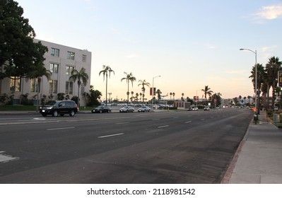 Beautiful San Diego Cityscape View. Asphalt Road With Parked Cars Merging With Pail Blue Cloudless Sky. USA. San Diego. 09.09.2014.