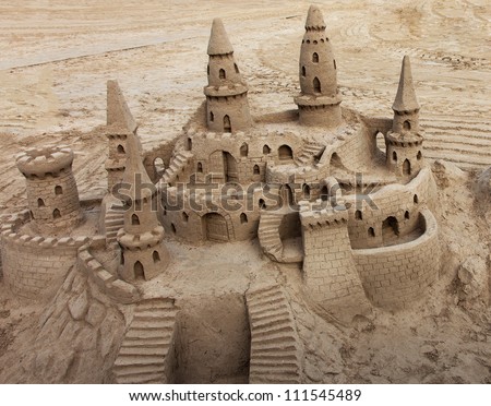 A beautiful sand castle on a beach.