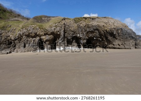 The beautiful sandy beach, with cliffs in the background, at Pendine, Carmarthenshire, Wales, UK.