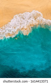 Beautiful sandy beach with turquoise sea, vertical view. Drone view of tropical turquoise ocean beach Nusa penida Bali Indonesia. Lonely sandy beach with beautiful waves. Beaches of Indonesia. 