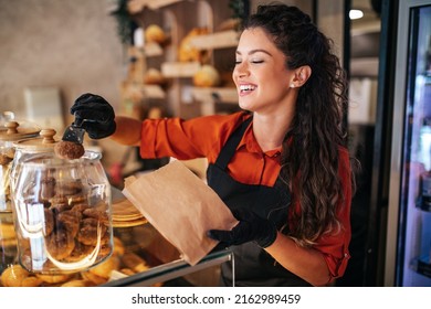 Beautiful and satisfied woman working in bakery. - Powered by Shutterstock