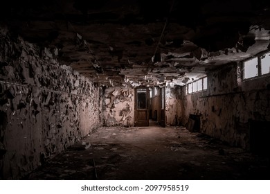 A Beautiful And Scary Corridor With Shabby Walls. Abandoned Building. Light From The Window On The Walls With Mold. An Old Broken Door. Scary Abandoned Manor.