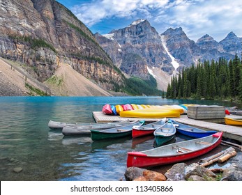 Beautiful Scene in one of the Rocky Mountain Lakes - Moraine Lake, Banff National Park - Canada. View of canoes on the dock by the lodge.