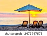 A beautiful scene of a private sandy beach with sun loungers facing the mountains and the sea. Amara Dolce Vita Resort and Luxury Hotel