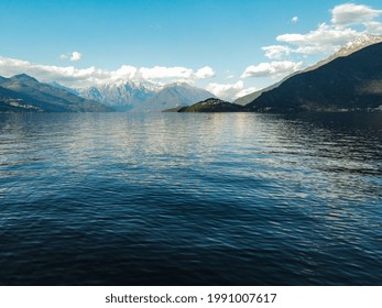 A beautiful scenery of a calm lake surrounded by hills under the cloudy sky