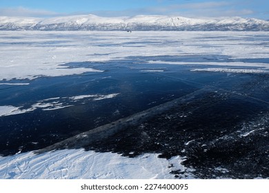 Beautiful scenery of frozen lake Torneträsk (Tornestrask) around Abisko National Park (Abisko nationalpark). Deep cracks in the ice sheet.  Sweden, Arctic Circle, Swedish Lapland - Shutterstock ID 2274400095
