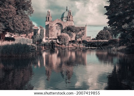 Beautiful scenery of Galway cathedral by the canal of Corrib river with reflecions in the water in Ireland 