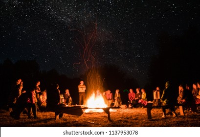 beautiful scenery of night vision. bonfire around people. basking by the fire at night. the concept of outdoor activities.
