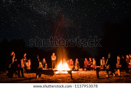 beautiful scenery of night vision. bonfire around people. basking by the fire at night. the concept of outdoor activities.