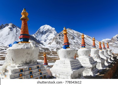 Beautiful scenery North face of sacred Kailash mountain covered with snow with group of white tibetan chortens(pagoda) in foreground and clear blue sky in background,Tibet,China
