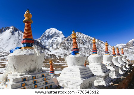 Beautiful scenery North face of sacred Kailash mountain covered with snow with group of white tibetan chortens(pagoda) in foreground and clear blue sky in background,Tibet,China
