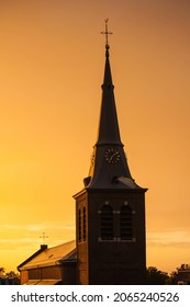 A Beautiful Scenery Of An Old Long Minaret With A Cross Against An Orange Sky At Sunset