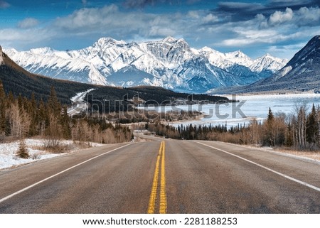 Beautiful scenery of Road trip on highway with rocky mountains and frozen lake at Icefields Parkway, Alberta, Canada