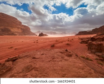 Schöne Landschaft Panoramasicht auf die Rote Sand-Wüste und die Alte Sandsteingebirge Landschaft im Wadi Rum, Jordanien während eines Sandsturms
