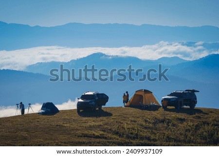 Beautiful scenery of the sea of mist in the morning at Camp Car Camping site with a viewpoint of is fresh nature of Doi Balu Kho Mountain, Mae Chaem, Chiang Mai, Northern Thailand. Background concept.